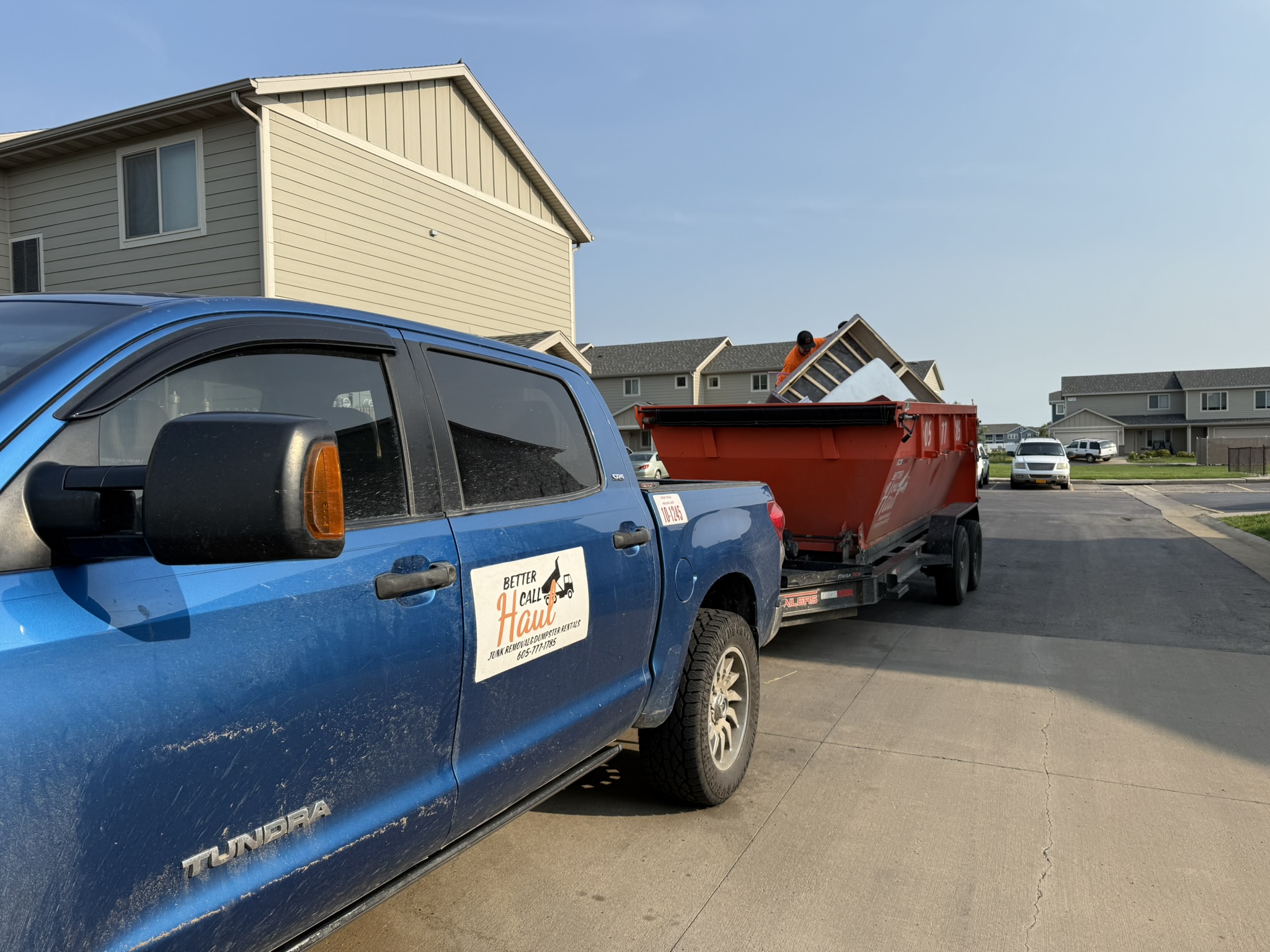 Better Call Haul truck delivering a dumpster